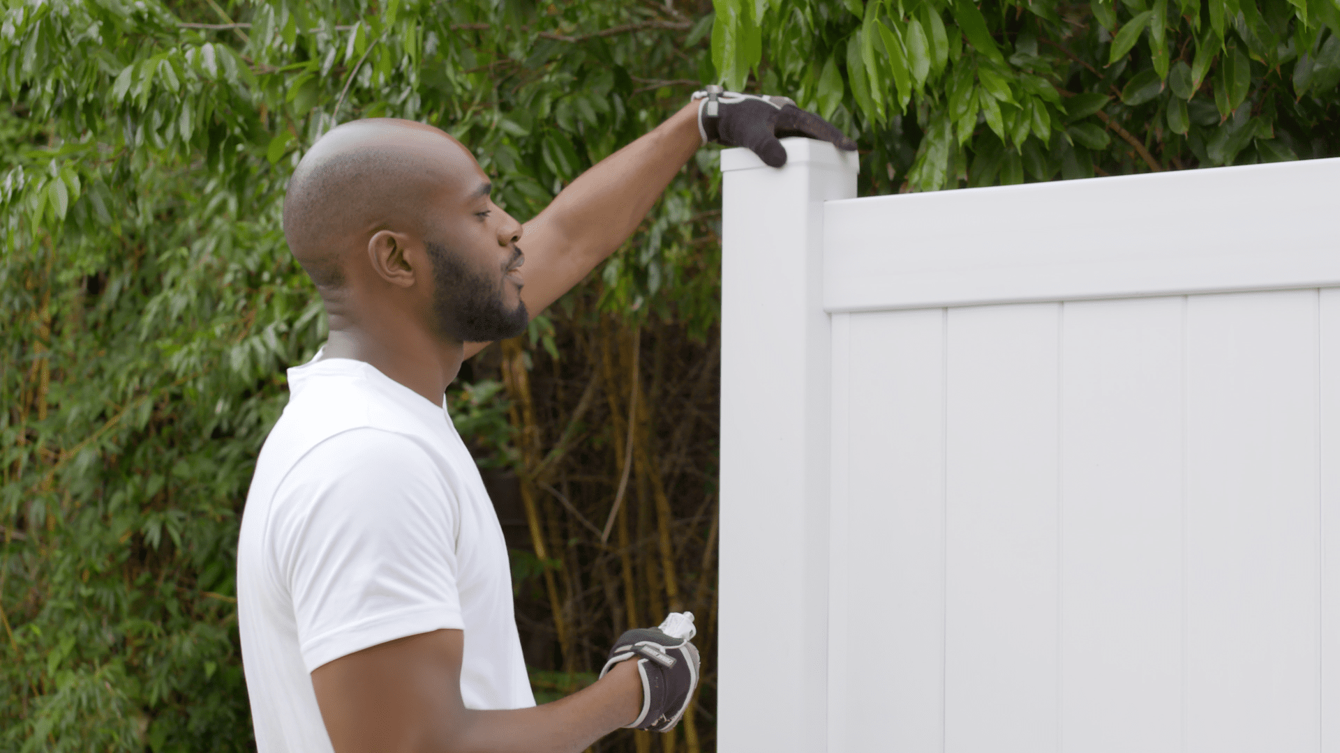 Vinyl Fence in a Box panel being installed in backyard